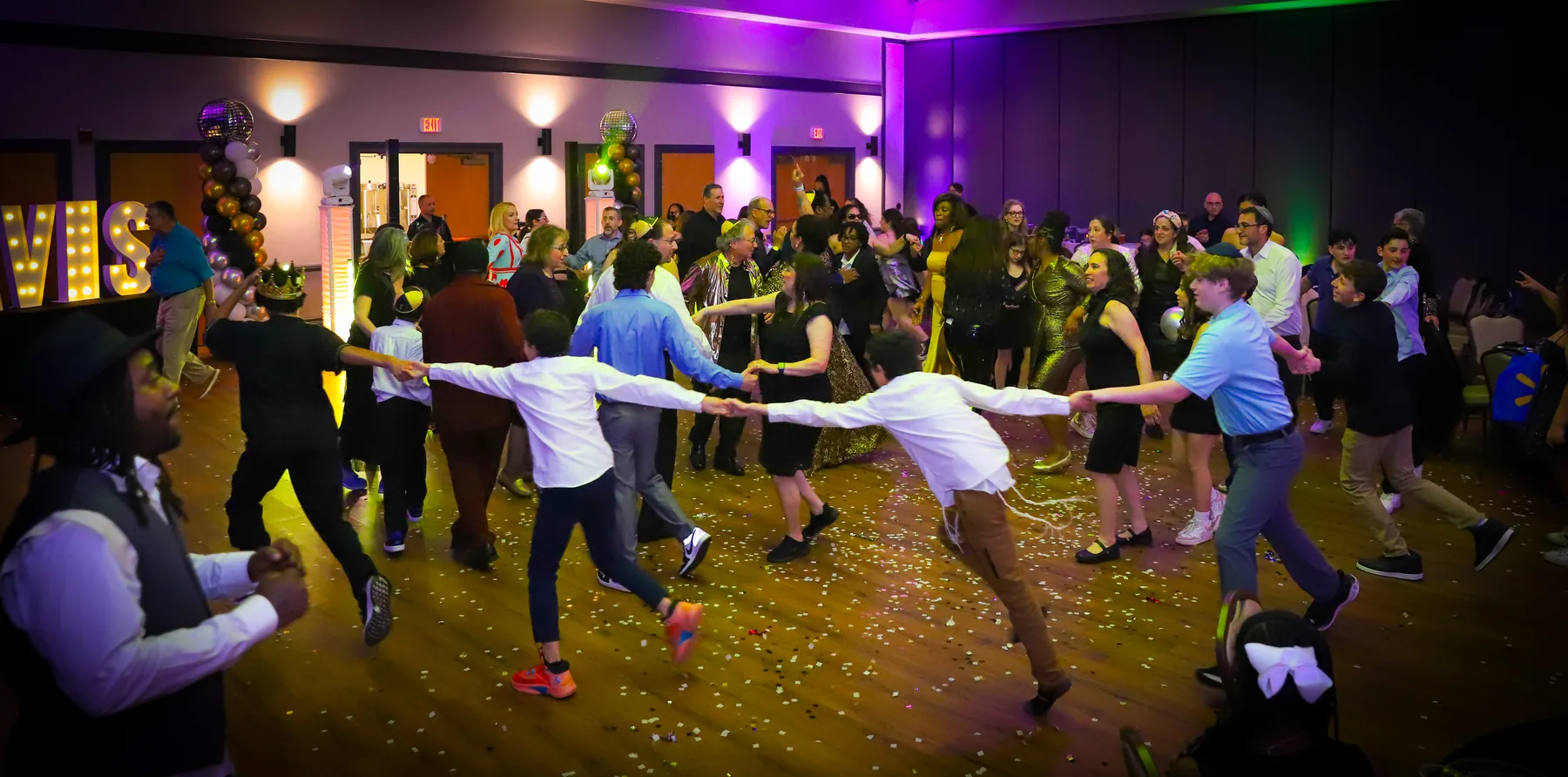 Guests celebrating together on a dance floor